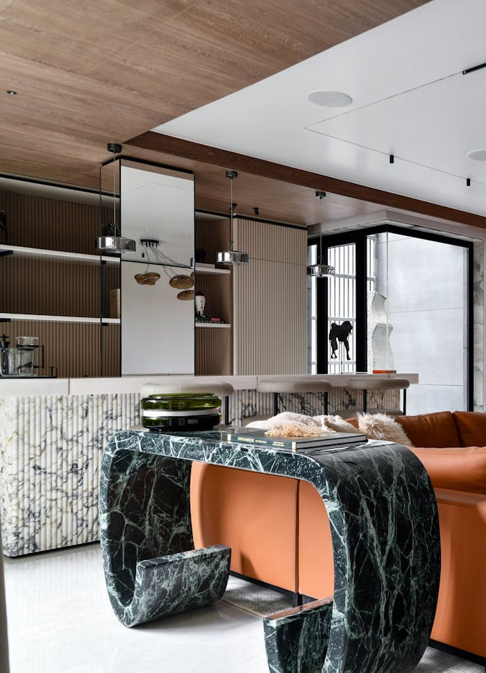 contact-img Sophisticated living room with marble elements and modern furniture design.
